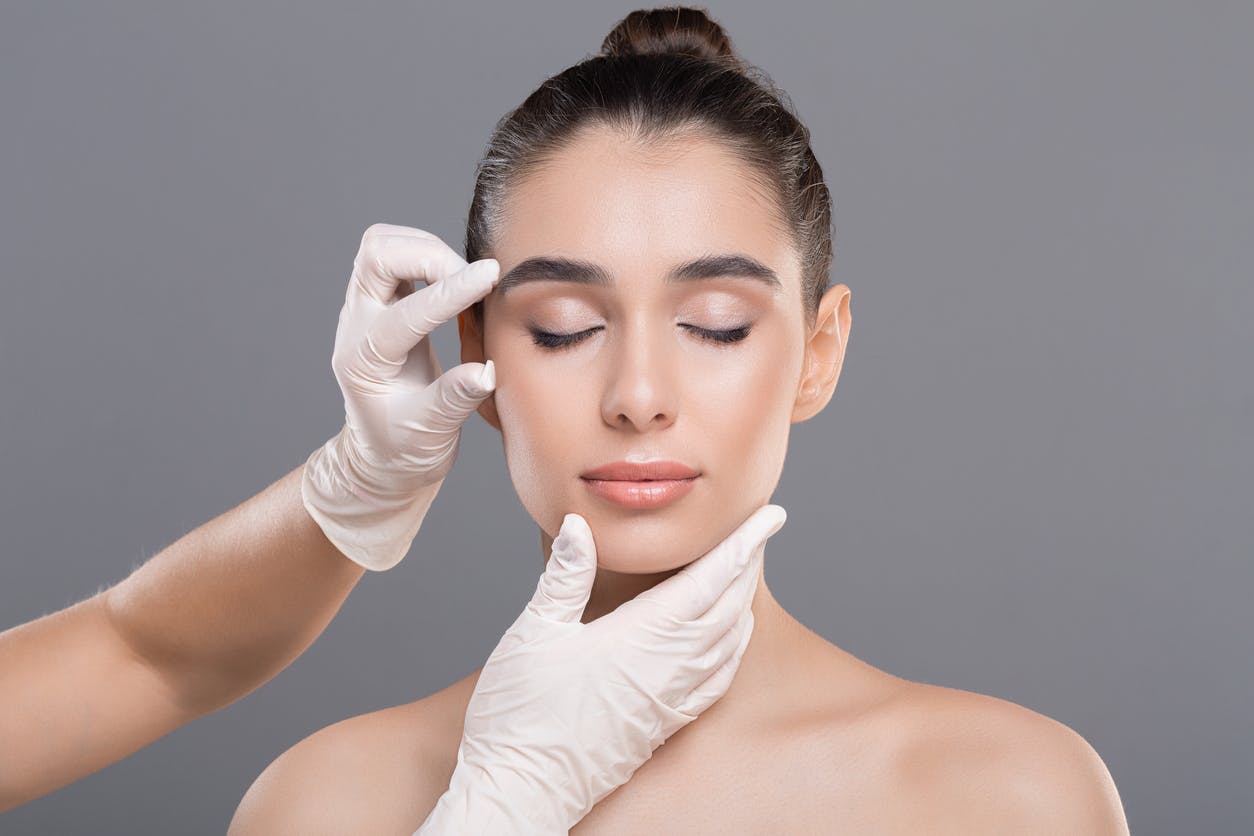Doctor examining woman's face